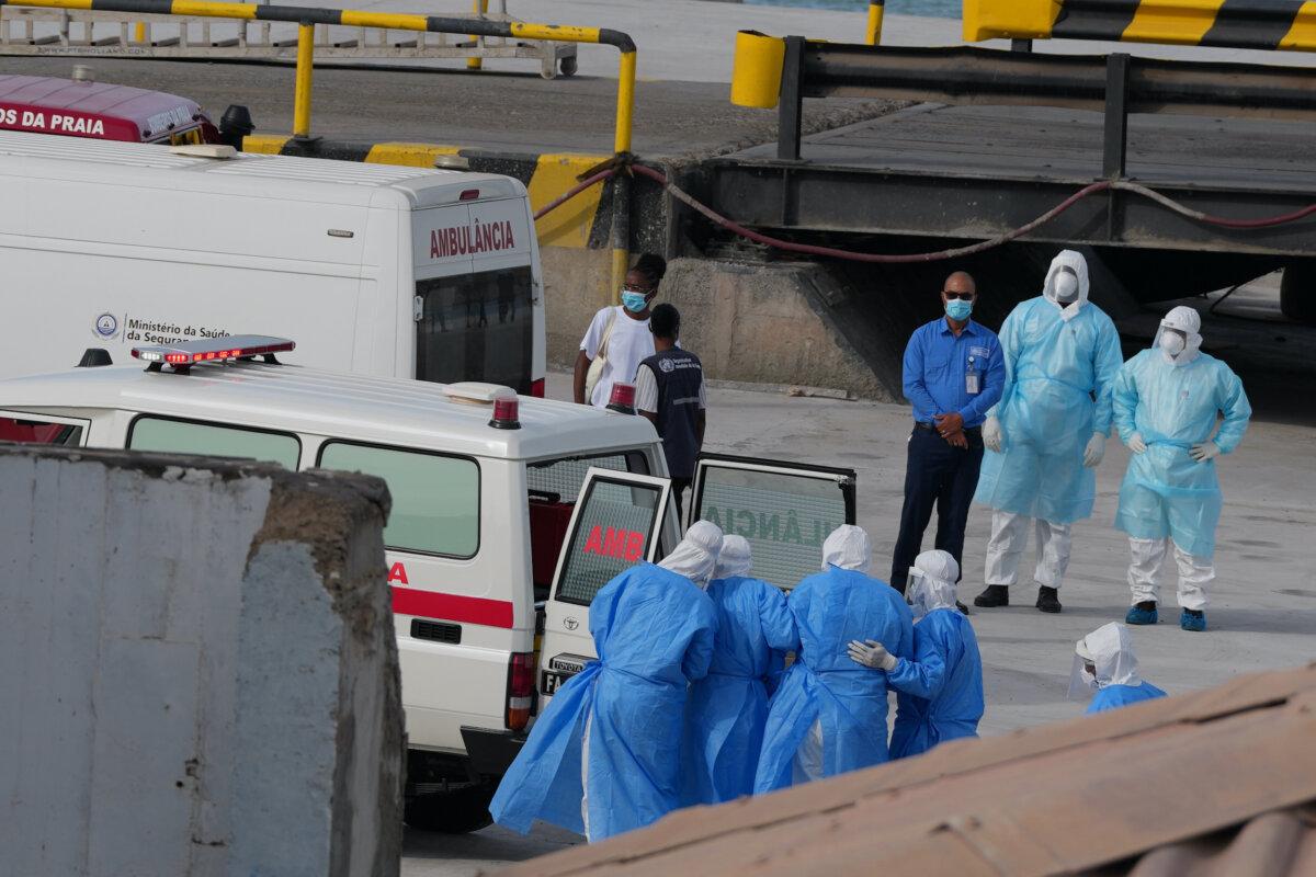 Health workers in protective gear evacuate patients from the MV Hondius cruise ship into an ambulance at a port in Praia, Cape Verde, on May 6, 2026. (Misper Apawu/AP)