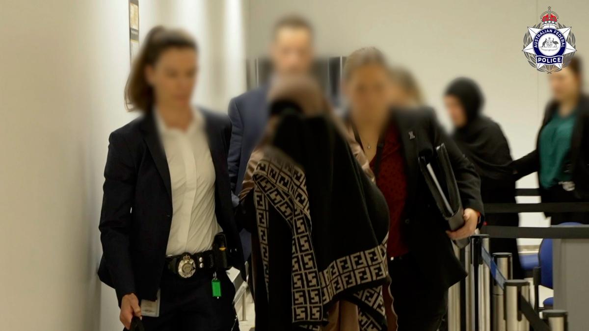 Australian Federal Police escort some of the ISIS cohort in Melbourne on the evening of May 7. (Courtesy of the Australian Federal Police)