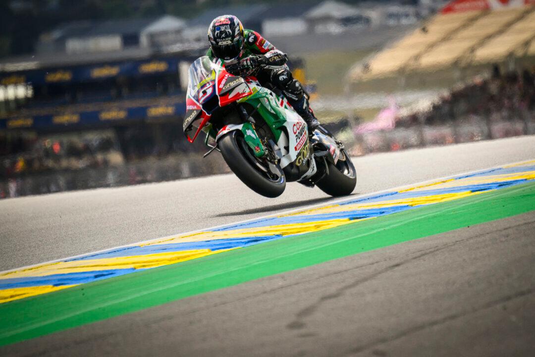 TOPSHOT - CASTROL Honda LCR's French rider Johann Zarco lifts his front wheel during the first practice session ahead of the French Moto GP Grand Prix of France at Le Mans, northwestern France, on May 8, 2026. (Photo by Loic VENANCE / AFP via Getty Images)