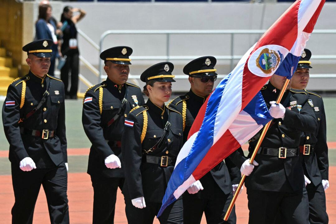 Costa Rican Public Force honor guard officers wave a national flag ahead of the inauguration ceremony of Costa Rica's President-elect Laura Fernandez at the National Stadium in San Jose on May 8, 2026. (Photo by MARTIN BERNETTI / AFP via Getty Images)