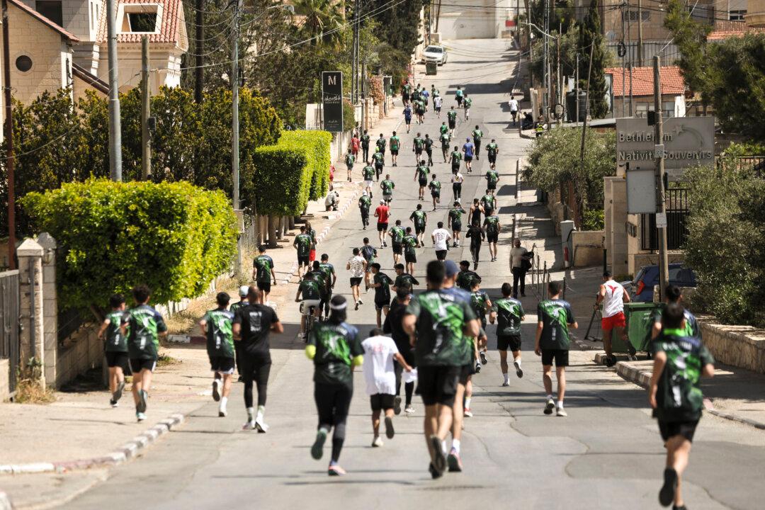 Runners take part in a marathon in Bethlehem in the Israeli-occupied West Bank on May 8, 2026. Organizers said about 13,000 Palestinians from the West Bank, Jerusalem, and Israel took part in the race, which called for freedom of movement. (Photo by Mosab Shawer / Middle East Images / AFP via Getty Images)