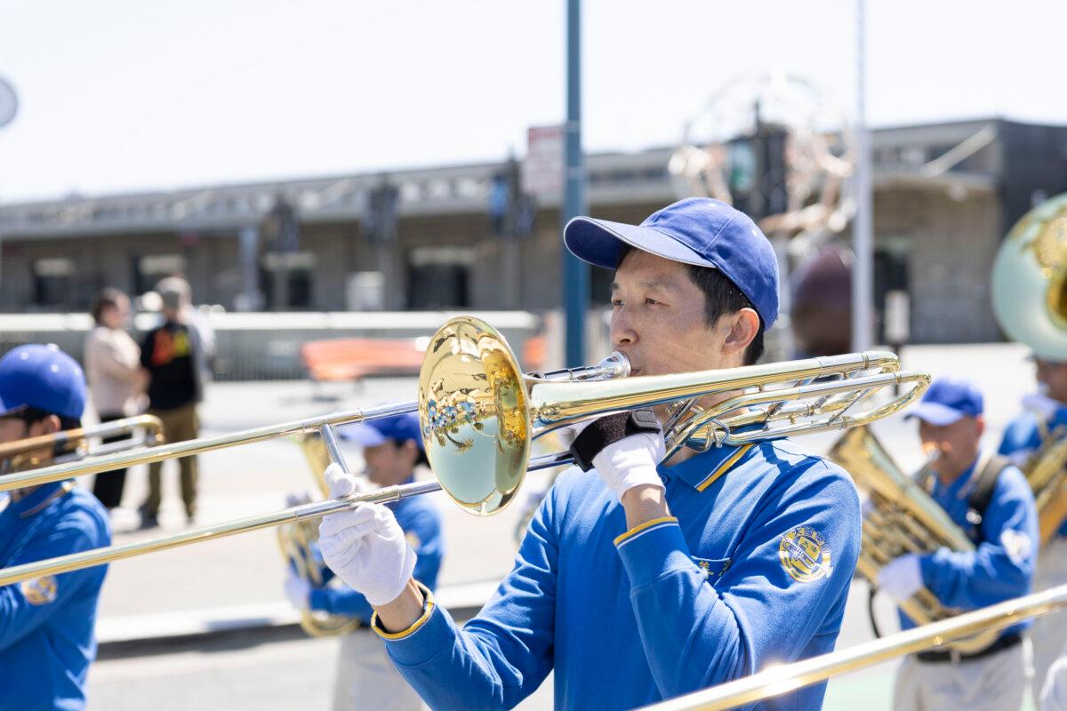 David Shi participates in the Tian Guo Marching Band in the Falun Dafa parade in San Francisco on May 9, 2026. (Lear Zhou/The Epoch Times)