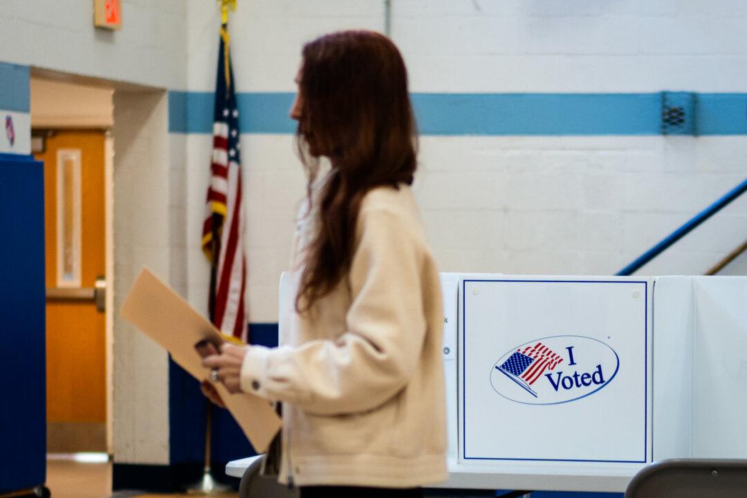 A voter at a polling site during the redistricting referendum in Alexandria, Va., on April 21, 2026. (Madalina Kilroy/The Epoch Times)