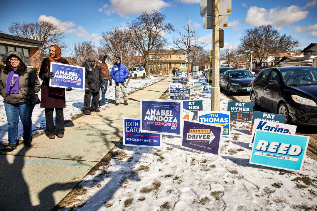Campaign signs are seen in Oak Park, Ill., on March 17, 2026. Under current law, party committees may spend unlimited amounts independently, but coordinated spending with campaigns is subject to federal caps. (Nathaniel Smith for The Epoch Times)