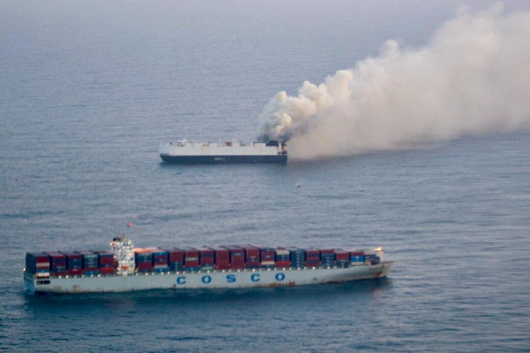 Smoke rises from the cargo vessel Morning Midas, about 300 miles south of Adak, Alaska, on June 3, 2025. The ship was carrying roughly 3,000 vehicles, including more than 700 electric and hybrid models, when it caught fire and sank. Multiple reports suggest the fire may have been related to an EV battery, due in part to the location where smoke was first detected. (U.S. Coast Guard photo courtesy of Air Station Kodiak)