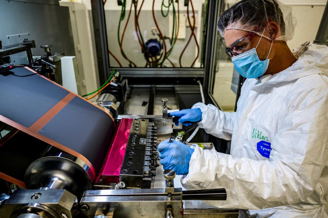 A technician shows how to calibrate an electrode coating machine at a Volkswagen Group battery cell research center in Salzgitter, Germany, on May 18, 2022. (John MacDougall/AFP via Getty Images)