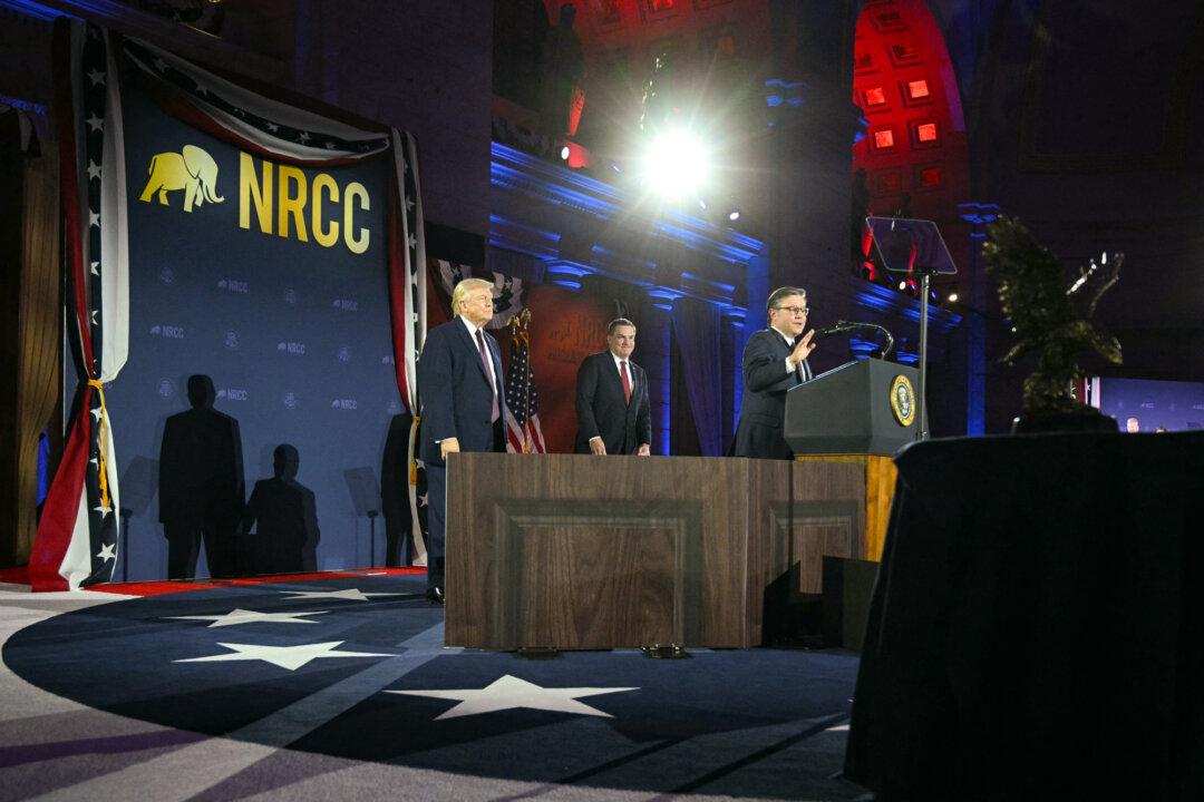 (L–R) President Donald Trump and NRCC Chairman Richard Hudson listen as House Speaker Mike Johnson (R-La.) speaks at the National Republican Congressional Committee’s annual President’s Dinner at Union Station in Washington on March 25, 2026. (Jim Watson/AFP via Getty Images)