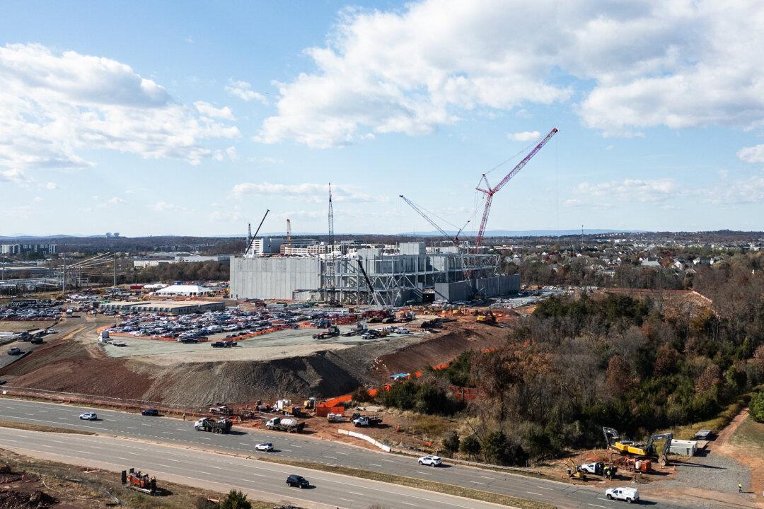 An aerial view shows cars passing a data center under construction in Ashburn, Va., on Nov. 12, 2025. More than 1,800 data centers are currently in various stages of development, adding to the more than 3,100 data centers in operation, according to data provided by Data Center Map. (Andrew Caballero-Reynolds/AFP via Getty Images)