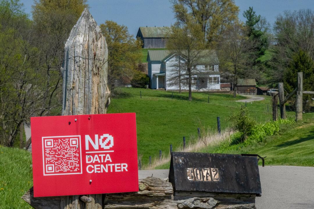 A sign reading “NO DATA CENTER” stands in front of the farm of Ida Huddleston and her daughter Delsia Bare in Maysville, Ky., on April 10, 2026. The family has turned down a large offer to sell their land as they and other Mason County property owners fight the building of a data center and solar farm on their properties. (Glenn Hartong for The Epoch Times)