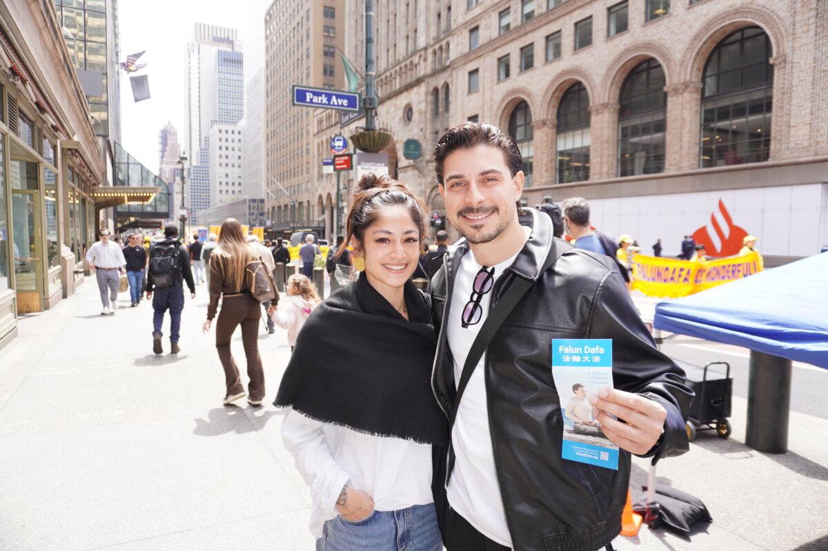 Swedish investment relations manager Alessio and his girlfriend, technical assistant Jenny, watched the Falun Dafa Day parade in Midtown Manhattan on May 13, 2026. (Yu Lili/The Epoch Times)