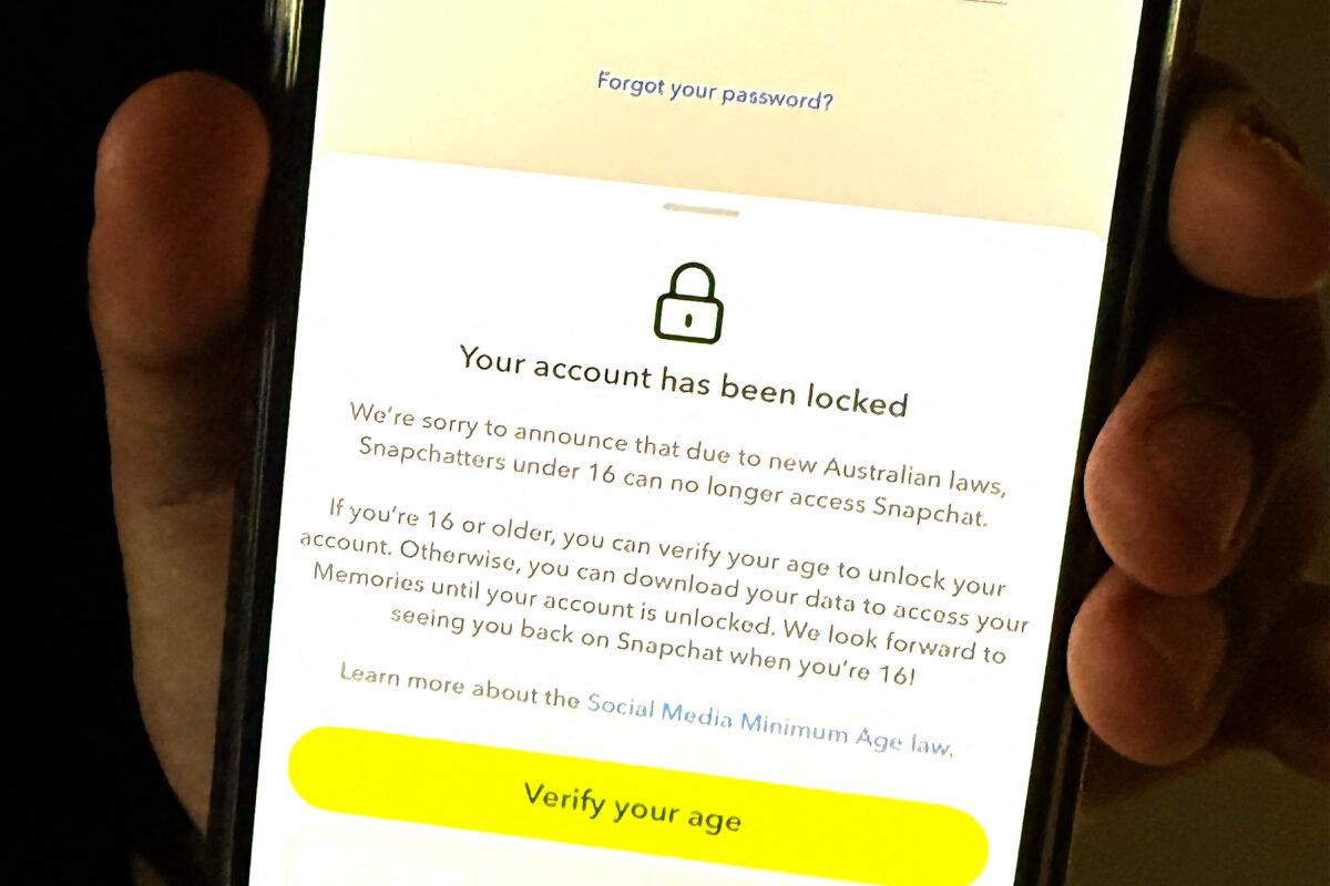 A 13-year-old boy displays a message on his mobile phone from social media platform Snapchat after his account was locked for age verification in Sydney, Australia, on Dec. 9, 2025. (AFP via Getty Images)