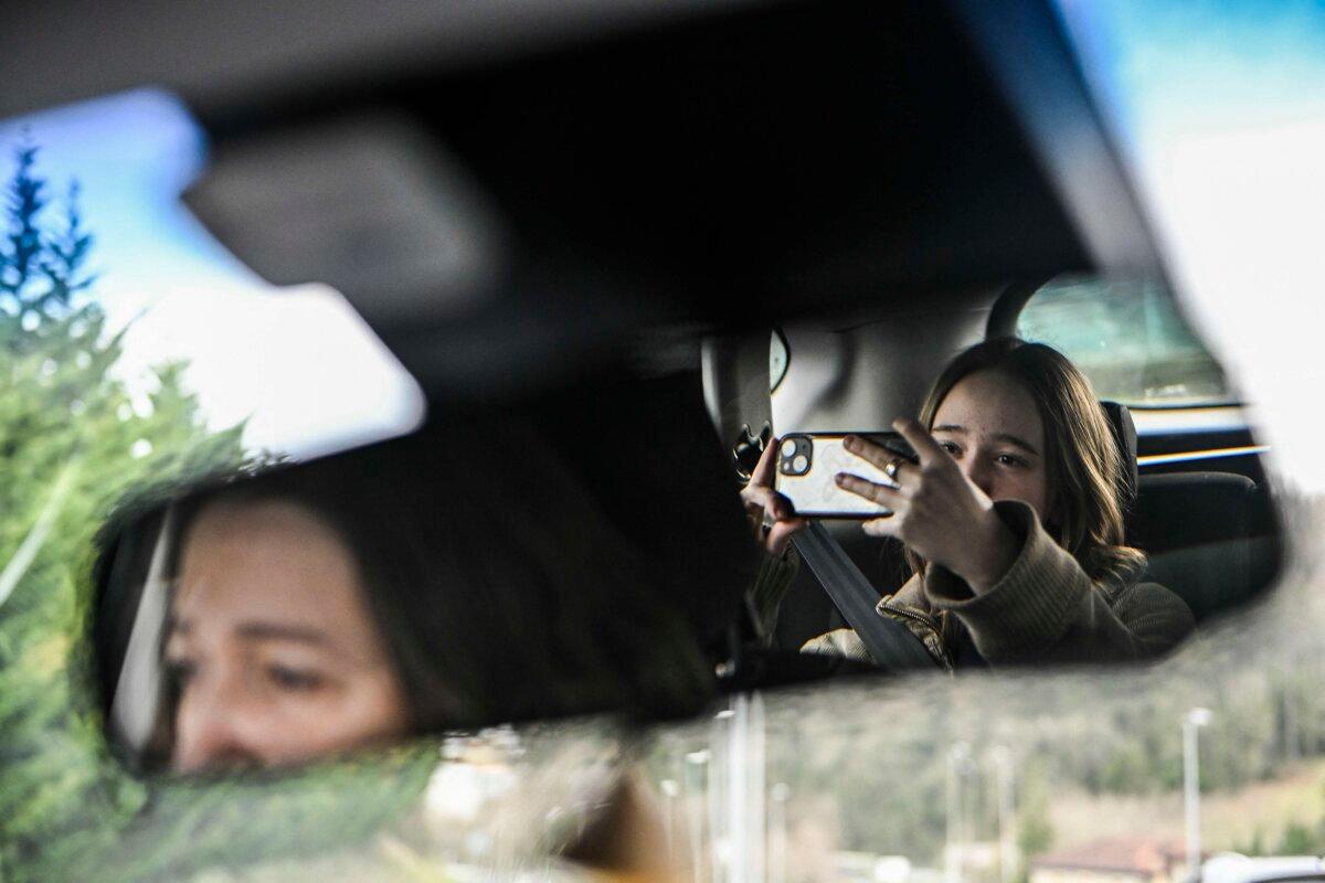 A teenager uses her phone in the Basque city of San Sebastian, Spain, on Feb. 4, 2026. (Ander Gillenea/AFP)