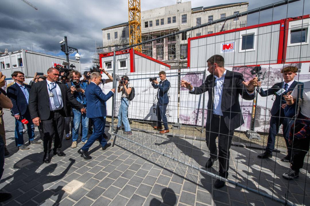 Hungarian Prime Minister Peter Magyar (L) and Hungarian Minister of Transportation and Investment David Vitezy (C) remove the fence around former Prime Minister Viktor Orban's office, Karmelita Monestry, in the Buda castle district in Budapest, Hungary, on May 15, 2026. (Photo by Ferenc ISZA / AFP via Getty Images)