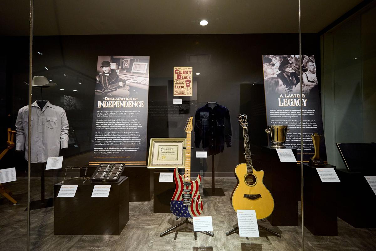 Installation view of “Clint Black: The Hard Way On Purpose” featuring two of his guitars, a Tom Anderson Guitarworks' sparkle-finish electric guitar (left) and a Taylor Clint Back Signature model with inlaid mother of pearl, as well as his set of Lee Oskar harmonicas. (Caroline Russell/Country Music Hall of Fame and Museum)