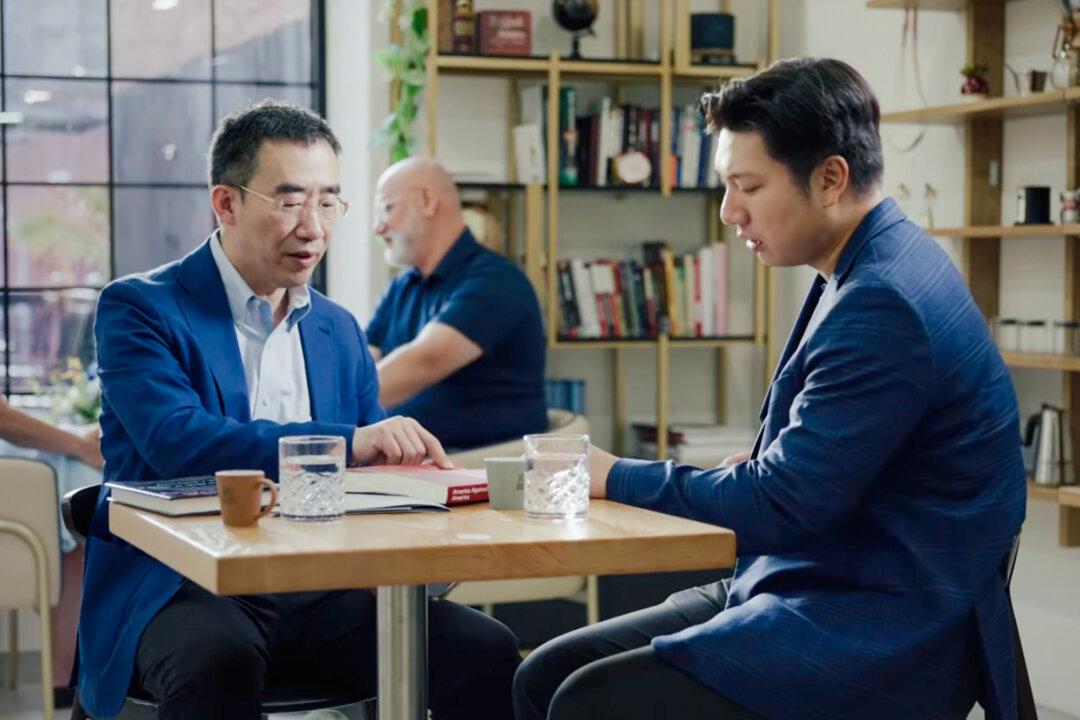 A still from the documentary “China’s Stealth Invasion” shows Zhang Tianliang (L), historian and professor at Fei Tian College, and David Zhang, host of YouTube channel China Insider. (Screenshot via The Epoch Times)
