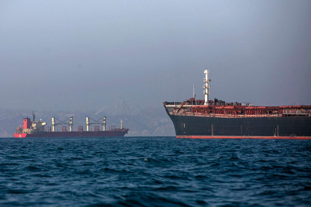 An Iranian tugboat is in the foreground as cargo ships sit at anchor in the Strait of Hormuz off Bandar Abbas, Iran, on May 4, 2026. (Amirhosein Khorgooi/ISNA via AP)