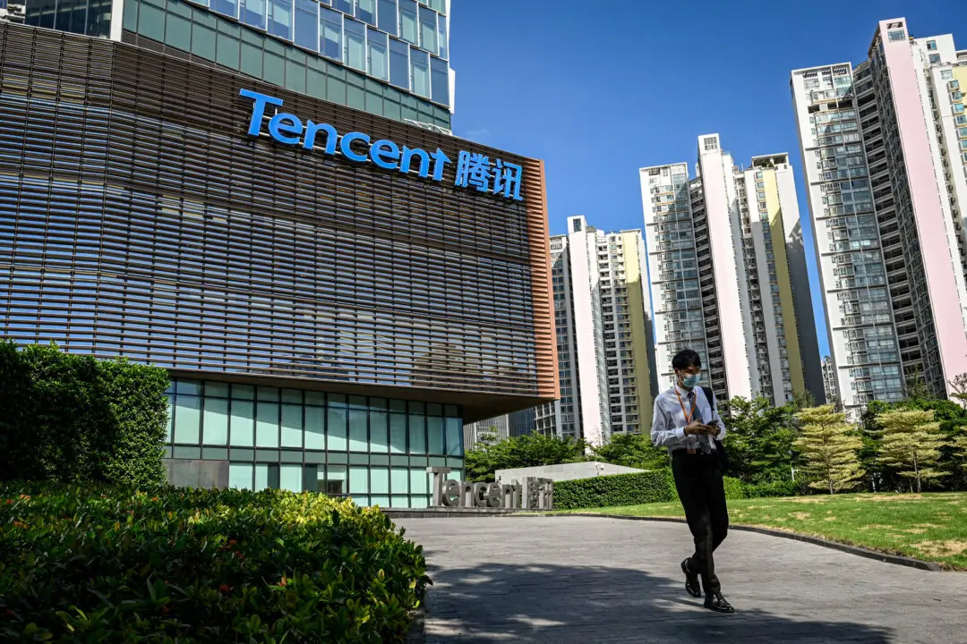 A man walks past Tencent’s headquarters in Shenzhen, Guangdong Province, China, on July 10, 2022. Reversing the deal may be difficult, Wang He said, as Manus employees have moved to Meta’s Singapore offices and investors—including Benchmark, Tencent, and HongShan—have reportedly been paid. (Jade Gao/AFP via Getty Images)