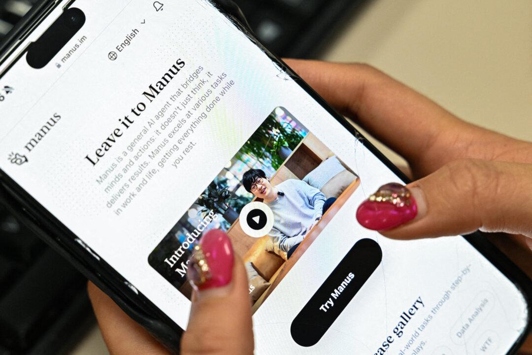 A photo illustration shows a mobile phone displaying an introduction screen of chief scientist Ji Yichao for the AI assistant Manus, released by Chinese startup Butterfly Effect, in Beijing on March 11, 2025. (Adek Berry/AFP via Getty Images)