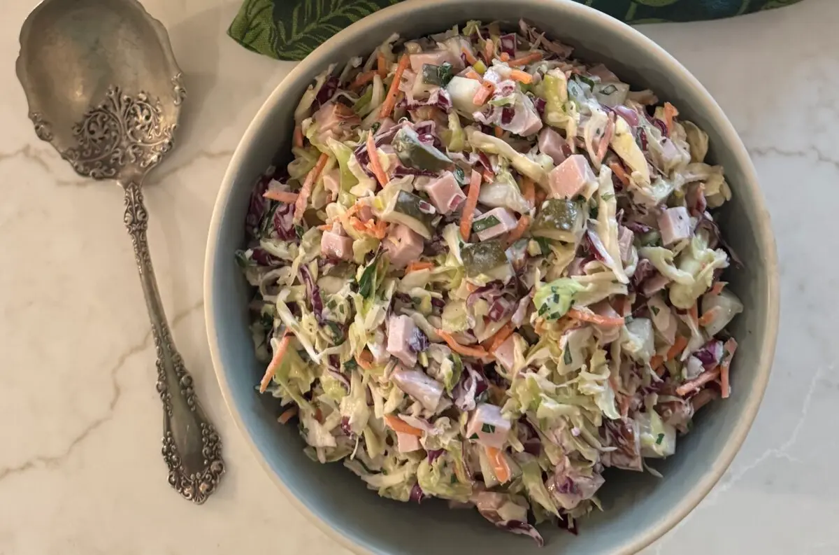 A bowl of chilled coleslaw topped with smoky ham captures the easygoing spirit of summer. (JeanMarie Brownson/TCA)
