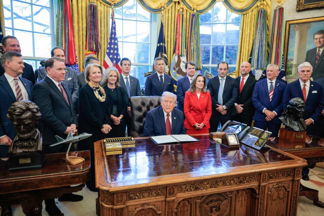 President Donald Trump (C) makes an announcement in the Oval Office on Dec. 3, 2025. Many Inflation Reduction Act initiatives and grants were suspended under the One Big Beautiful Bill Act, adopted in partisan votes and signed into law by Trump in July 2025. (Chip Somodevilla/Getty Images)