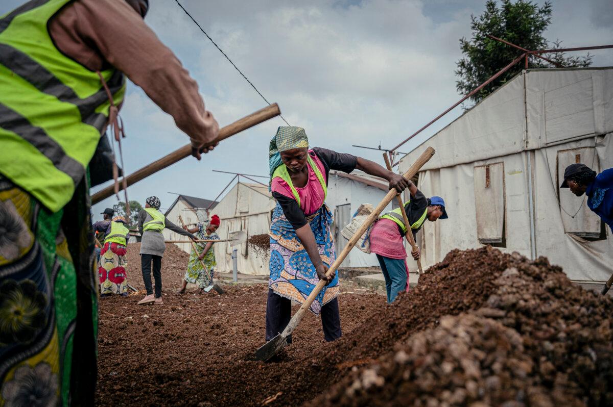 Workers from Kanyaruchinya, in Nyiragongo territory, take part in sanitation, renovation, and leveling work at the former Ebola treatment center, in Goma on May 19, 2026. (Jospin Mwisha/AFP via Getty Images)