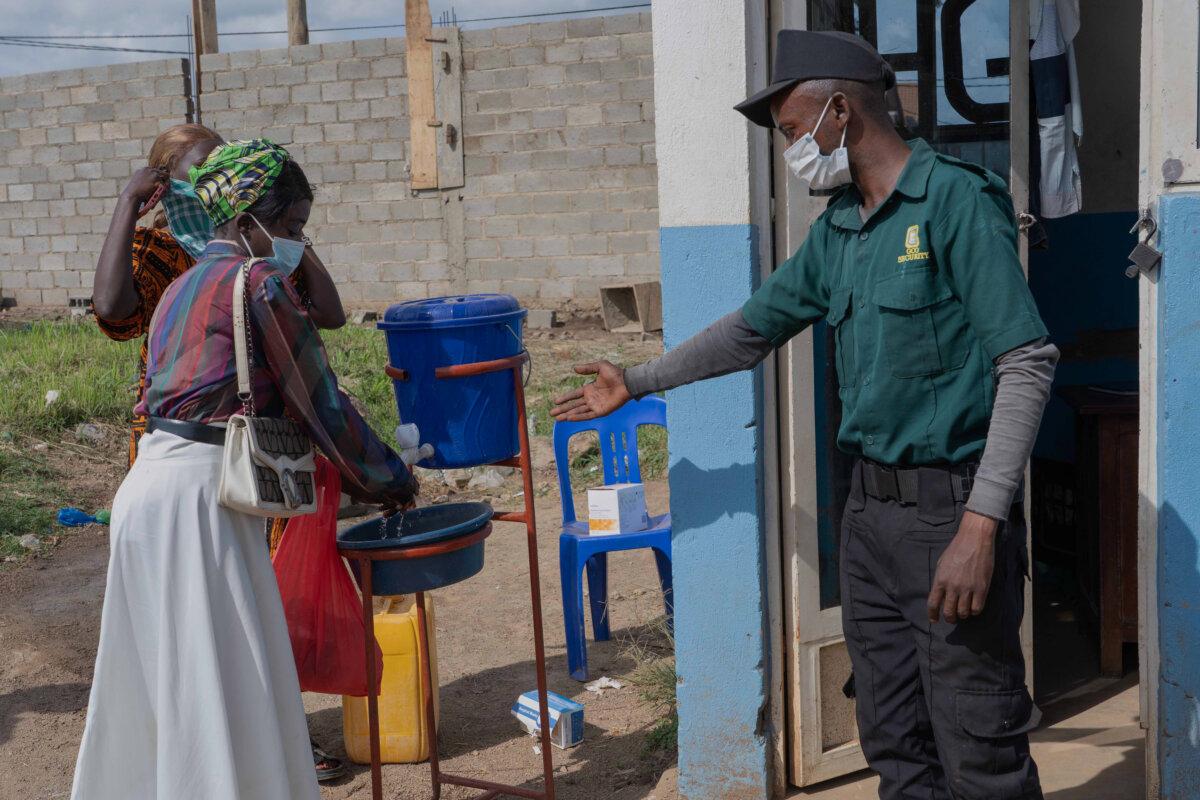 People wash their hands at the entrance to a hospital in Bunia, Congo, on May 17, 2026. (Dirole Lotsima Dieudonne/AP Photo)