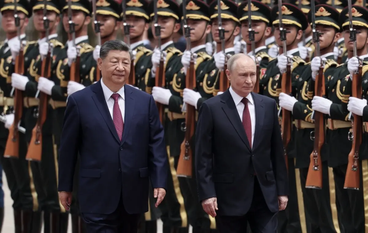 Russian President Vladimir Putin (R) and Chinese leader Xi Jinping inspect an honor guard during a welcoming ceremony in Beijing, China, on May 20, 2026. (Maxim Shemetov/Pool Photo via AP)