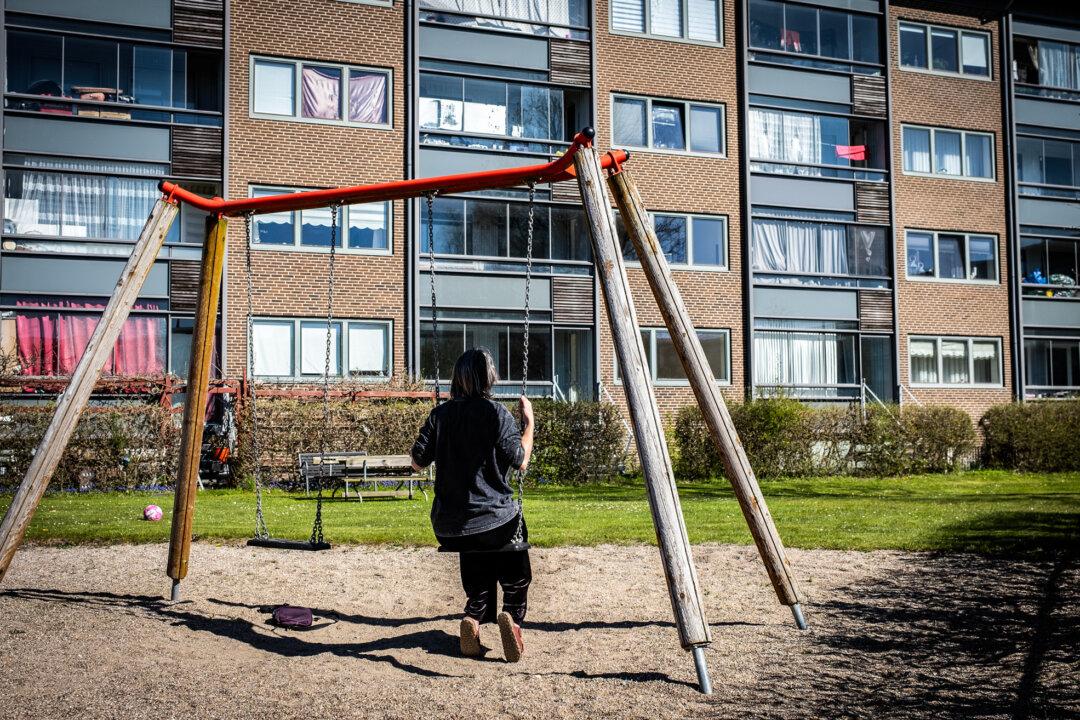A woman sits on a swing set outside of Aarhus, Denmark, on April 22, 2026. (John Fredricks/The Epoch Times)