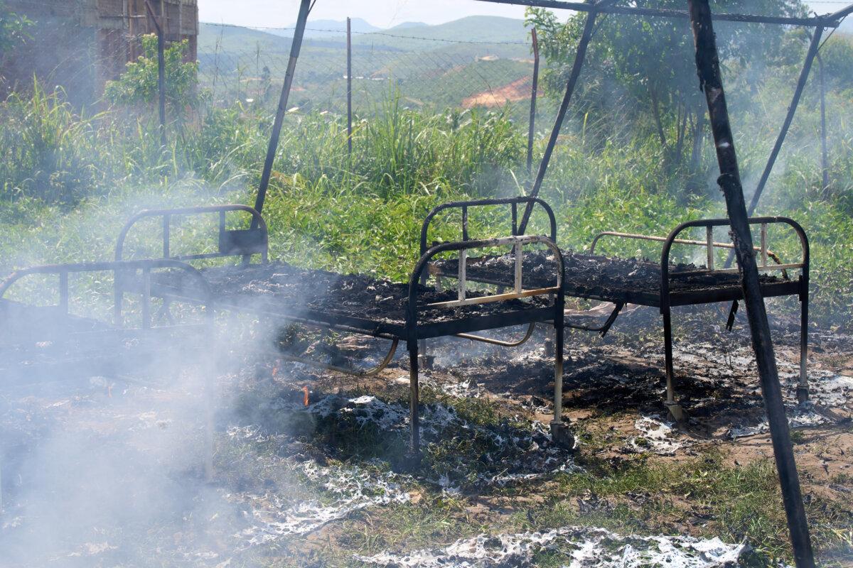 Charred hospital beds stand in a smoldering Ebola treatment center in Rwampara, Congo, on May 21, 2026. (Dirole Lotsima Dieudonne/AP Photo)