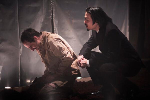 Clifton Frei (L) as Raskolnikov and Huy Nguyen as Porfiry. Raskolnikov confronts his unraveling conscience in TUTA Theatre’s intense revival of “Crime and Punishment.” (Logan and Candice Conner, Oomphotography)