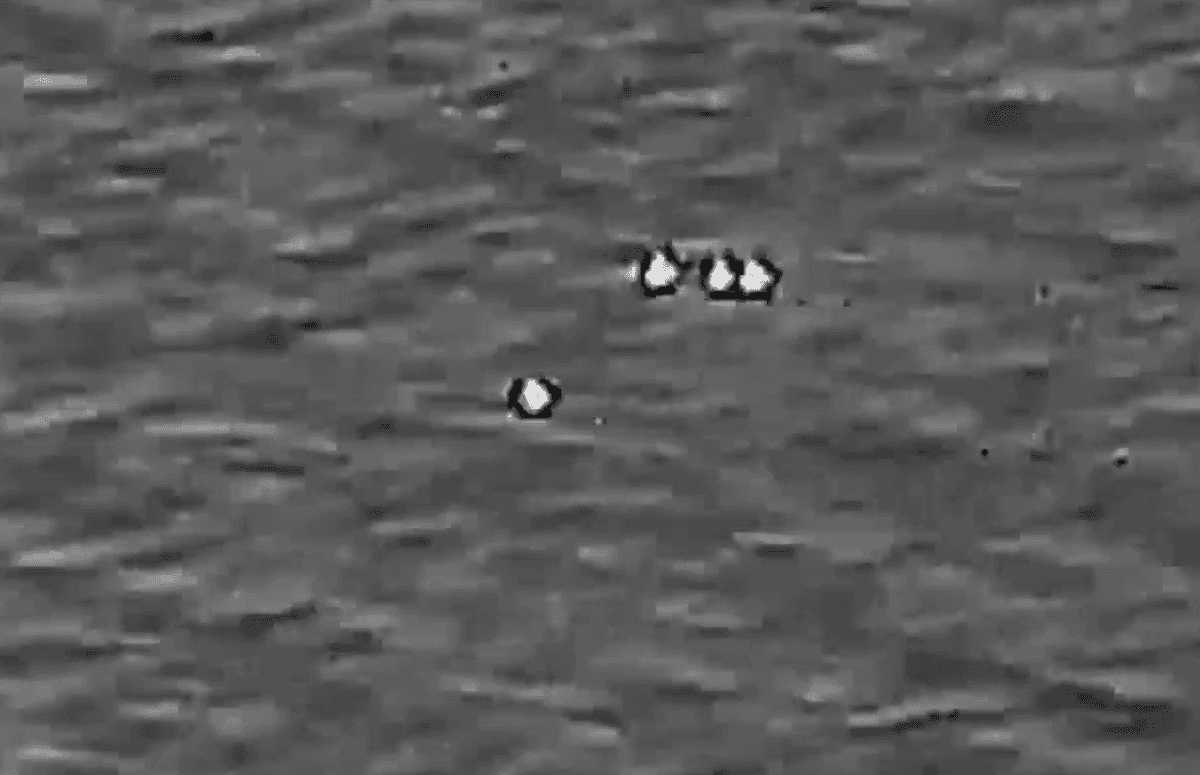 Pentagon UFO Files Released: Everything About the 2026 UAP Disclosure 9 Four unexplained objects moving in the same direction in a screenshot from video. Department of War