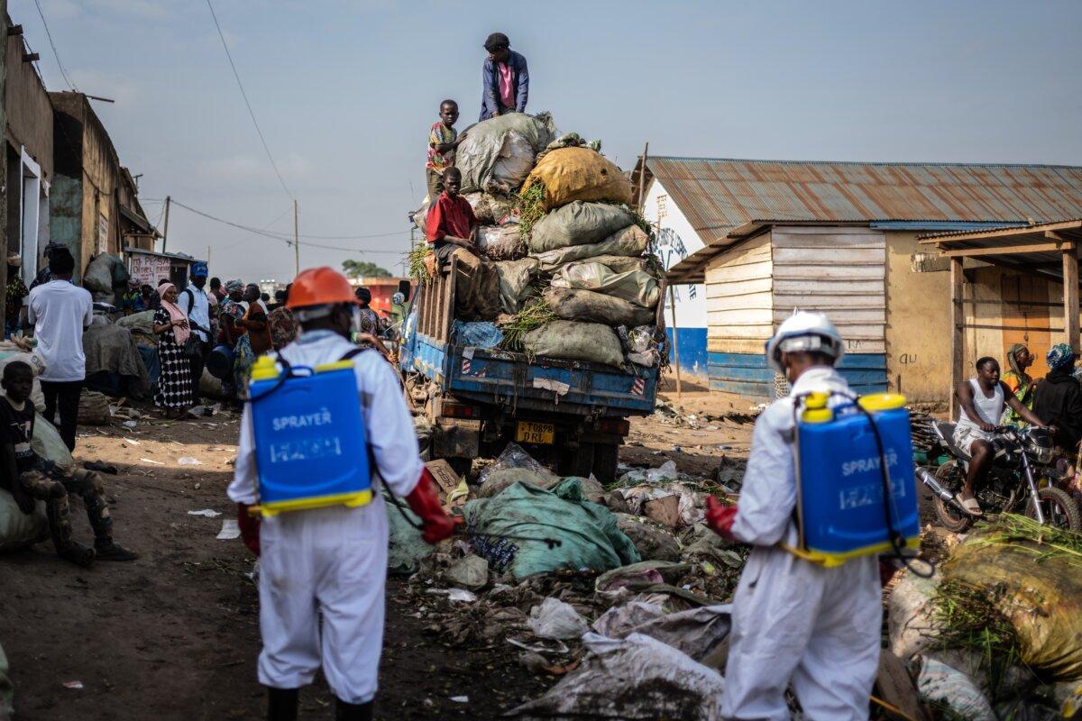 Sanitation workers from Bunia city government spray disinfectant in the central market area near a rubbish truck in Ituri province, as they continue efforts to combat the Ebola outbreak in Bunia, Congo, on May 23, 2026. (Moses Sawasawa/AP Photo)