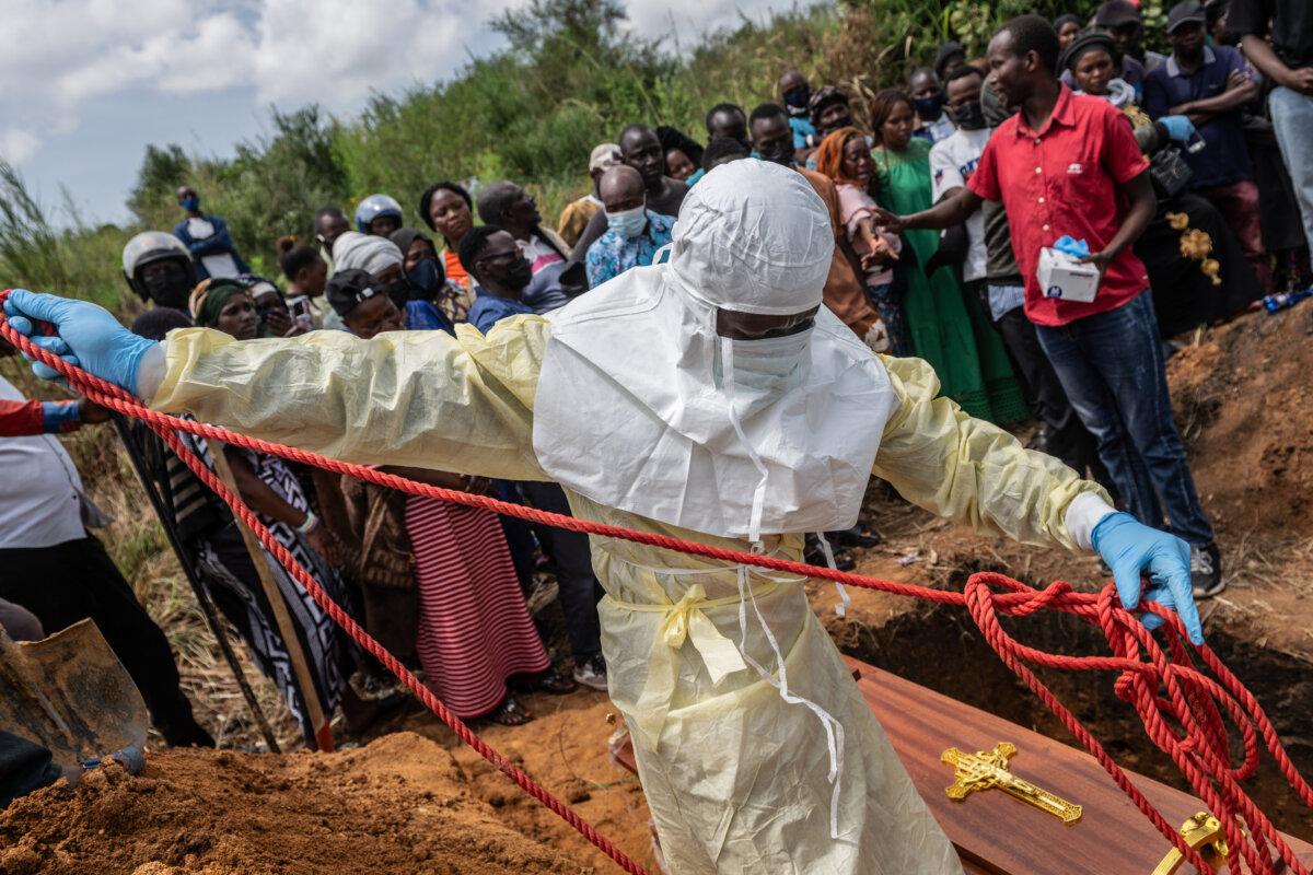 Red Cross workers prepare a coffin containing the body of an Ebola victim for burial at the Rwampara Cemetery in Rwampara, Congo, on May 23, 2026. (Moses Sawasawa/AP Photo)
