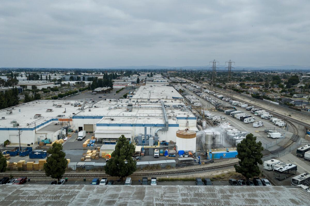 Water is sprayed on a damaged tank after the tank containing a chemical used to make plastic parts overheated at GKN Aerospace in Garden Grove, Calif., on May 24, 2026. (AP Photo/Ethan Swope)