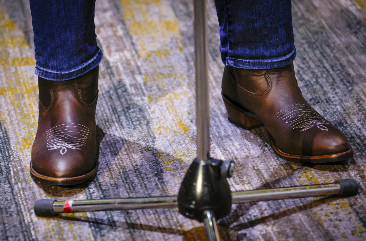 B.C. Premier David Eby wears new cowboy boots given to him by Alberta Premier Danielle Smith as he speaks to the media at a meeting of western premiers in Kananaskis, Atla., on May 25, 2026. (The Canadian Press/Jeff McIntosh)