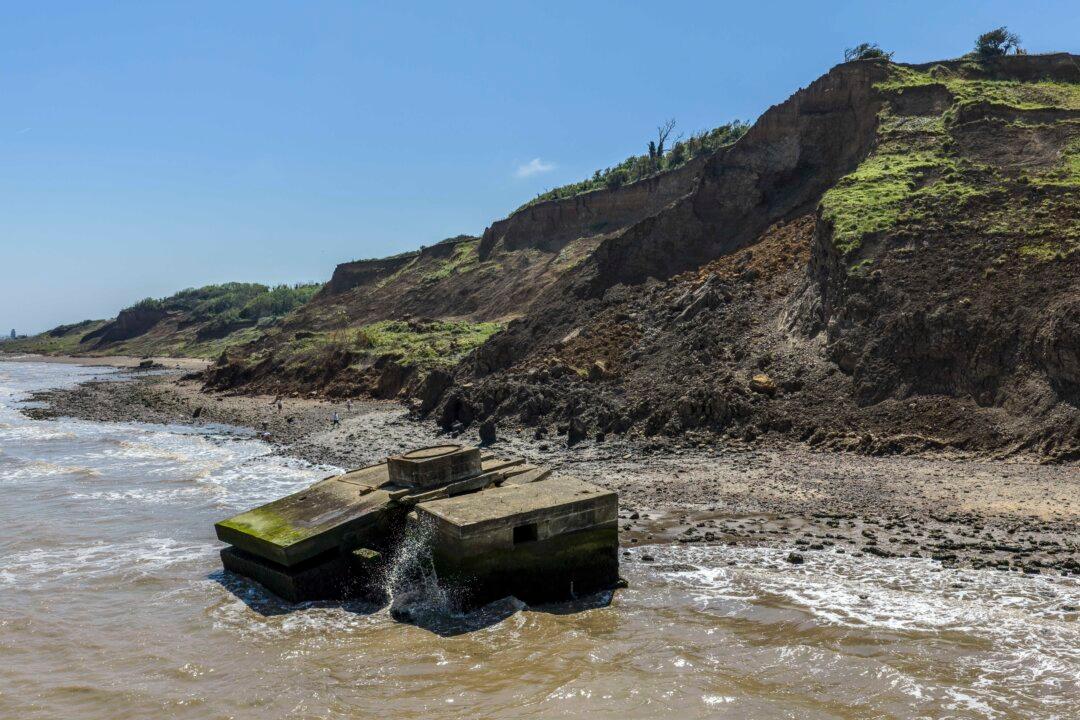ISLE OF SHEPPEY, ENGLAND- MAY 27: Waves lap around a World War II pill box that has fallen into the sea following years of costal erosion, on May 27, 2026 in Isle of Sheppey, England. The Isle of Sheppey is among the worst affected areas in Britain for coastal erosion with the northern part of the island losing an average of one to two metres each year. The soft, unstable London Clay cliffs, wave undercutting and climate change are the primary factors in the rapid erosion of the shoreline. (Photo by Carl Court/Getty Images)