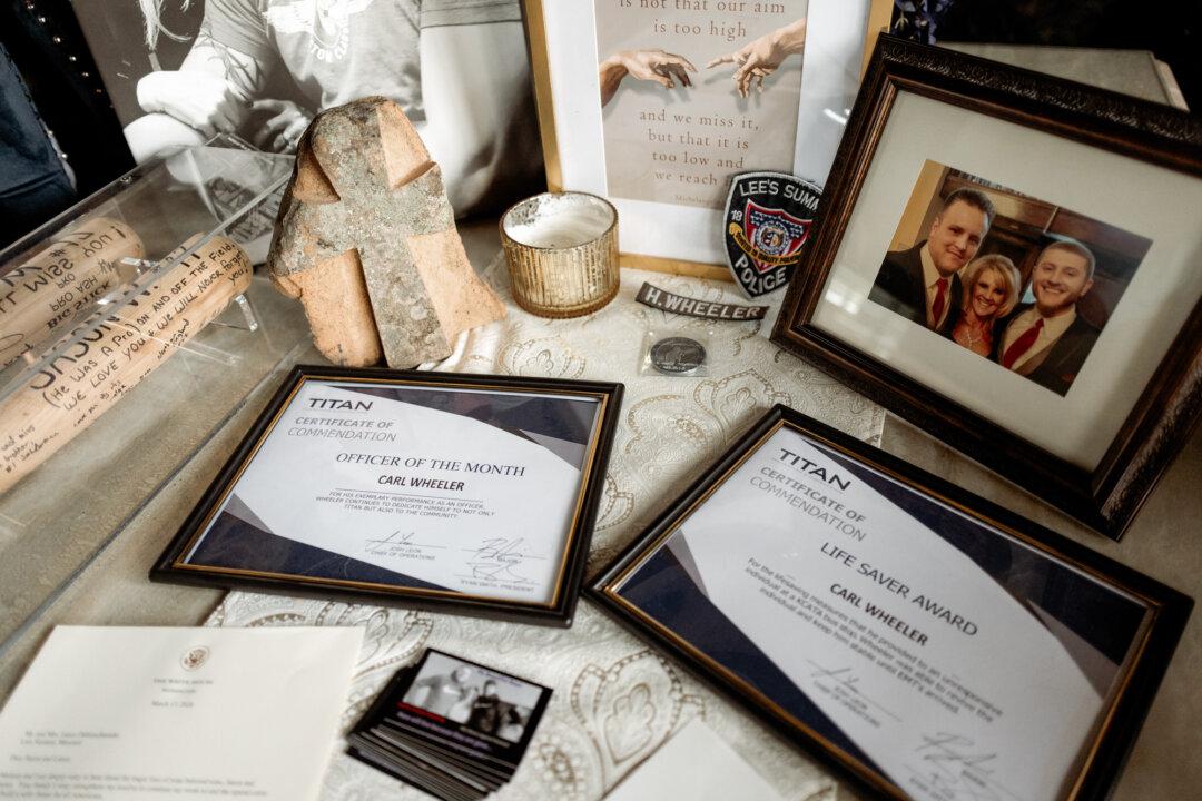 Certificates, photos, and memorial items belonging to Hunter Wheeler are displayed in Lee’s Summit, Mo., on May 23, 2026. Hunter died at the age of 32 after taking a pill laced with carfentanil—a cousin of fentanyl but 100 times more potent. (Liz Davenport for The Epoch Times)