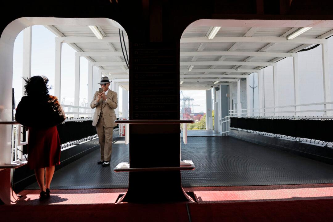 LONG BEACH, CALIFORNIA - MAY 27: People take photos at the historic Queen Mary during a celebration marking the 90th anniversary of its maiden transatlantic voyage on May 27, 2026 in Long Beach, California. The iconic British Cunard Line ocean liner first set sail from Southampton, England to New York City on May 27, 1936 and is now permanently anchored in Long Beach. The ship now serves as a floating hotel, museum, and event venue. (Photo by Mario Tama/Getty Images)
