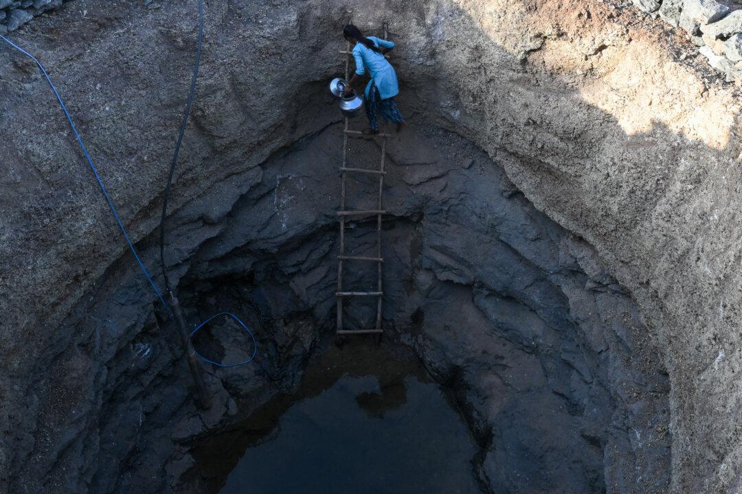 VALSAD, INDIA - MAY 27: Sangeeta, a 16 years old girl, climbs down into a deep well to collect water in a drought affected village, on May 27, 2026 in Kaprada taluka of Valsad district, Gujarat, India. (Photo by Ritesh Shukla/Getty Images)