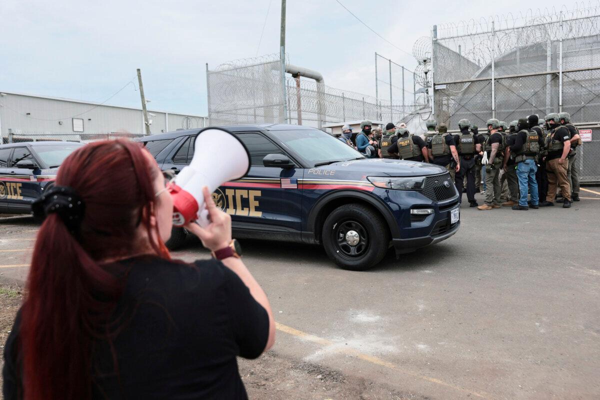 Immigration and Customs Enforcement (ICE) agents stand guard in front of protesters outside Delaney Hall in Newark, N.J., on May 27, 2026. (Michael M. Santiago/Getty Images)