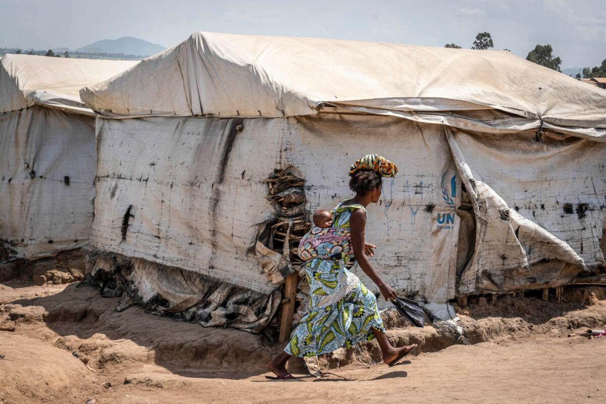 A displaced woman walks through the Kigonze camp in Bunia, Congo, on May 28, 2026. (Glody Murhabazi/AFP via Getty Images)