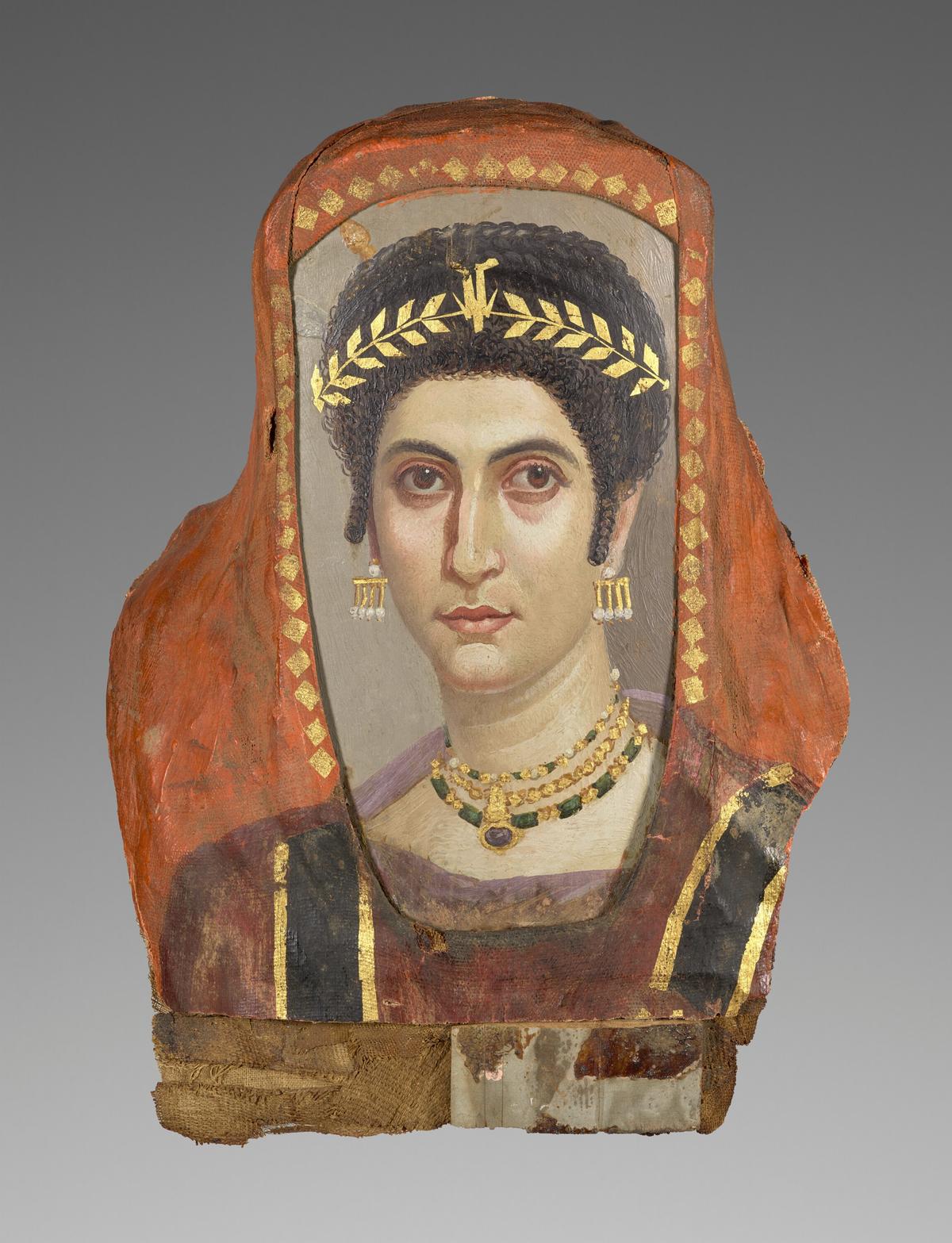 A Romano-Egyptian mummy portrait of a woman, circa A.D. 100–110, attributed to the Isidora Master. Encaustic on linden wood, gilt, linen: 18 7/8 inches by 14 3/16 inches. Getty Museum, Los Angeles. (Public Domain)