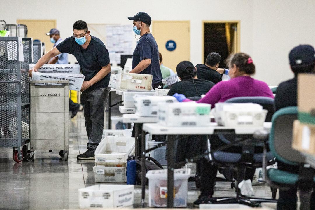 People count California recall ballot votes at a Los Angeles Registrar site at the Los Angeles Fair Grounds in Pomona, Calif., on Aug. 31, 2021. The effort to recall California Gov. Gavin Newsom, a Democrat, was rejected by the state's voters. (John Fredricks/The Epoch Times)