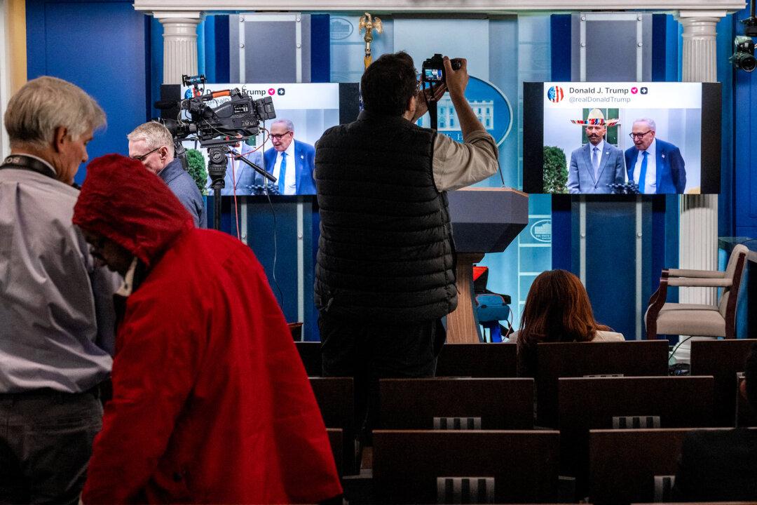 Journalists watch as an AI-generated fake video posted on U.S. President Donald Trump's Truth Social account plays in the Briefing Room at the White House on Oct. 1, 2025. Building on Trump's approach, other politicians have also adopted AI-generated content. (Jim Watson / AFP via Getty Images)