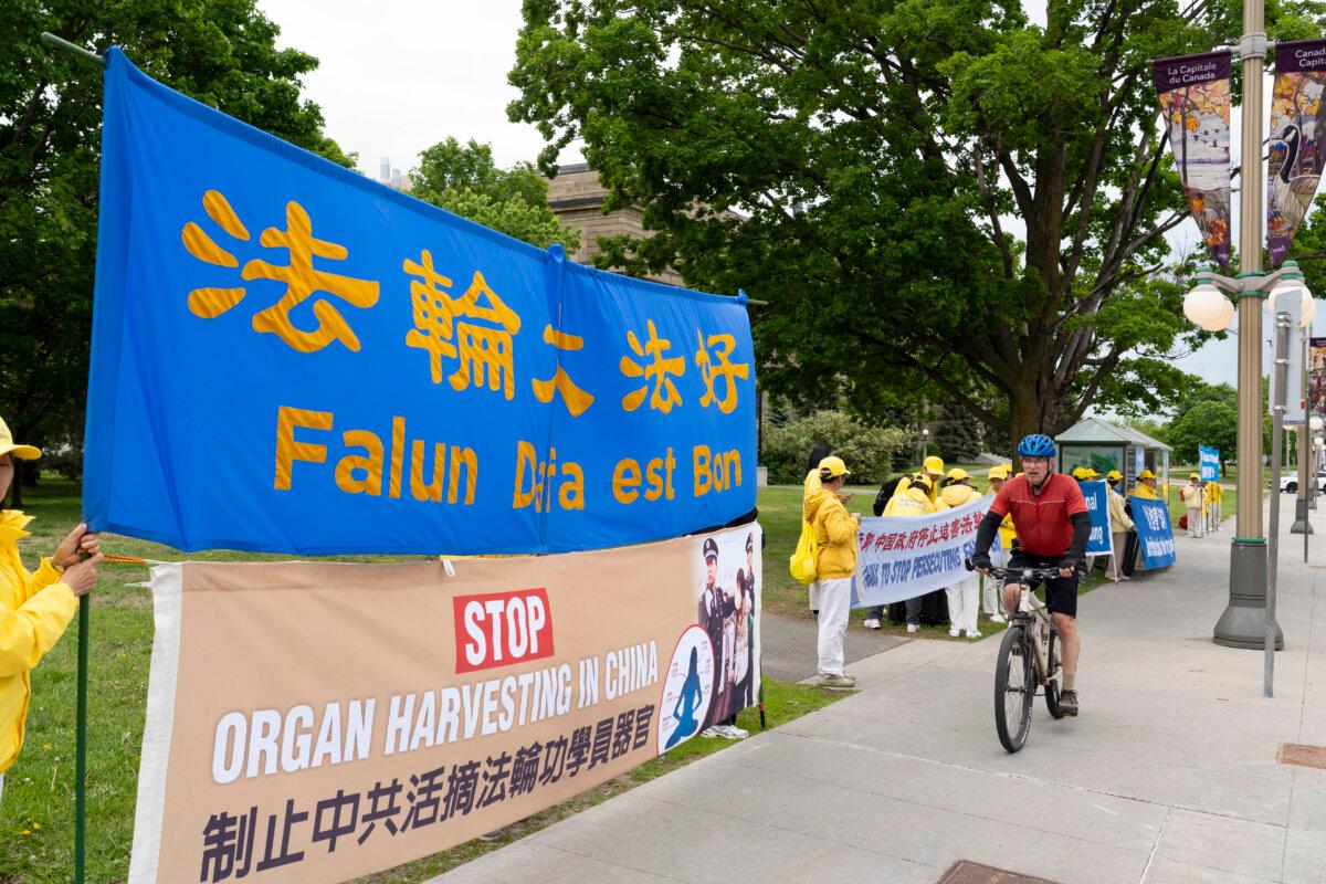 Falun Gong practitioners protest outside of the Foreign Affairs Canada headquarters in Ottawa as Chinese Foreign Minister Wang Yi meets with Canadian Foreign Affairs Minister Anita Anand on May 29, 2026. (Evan Ning/The Epoch Times)