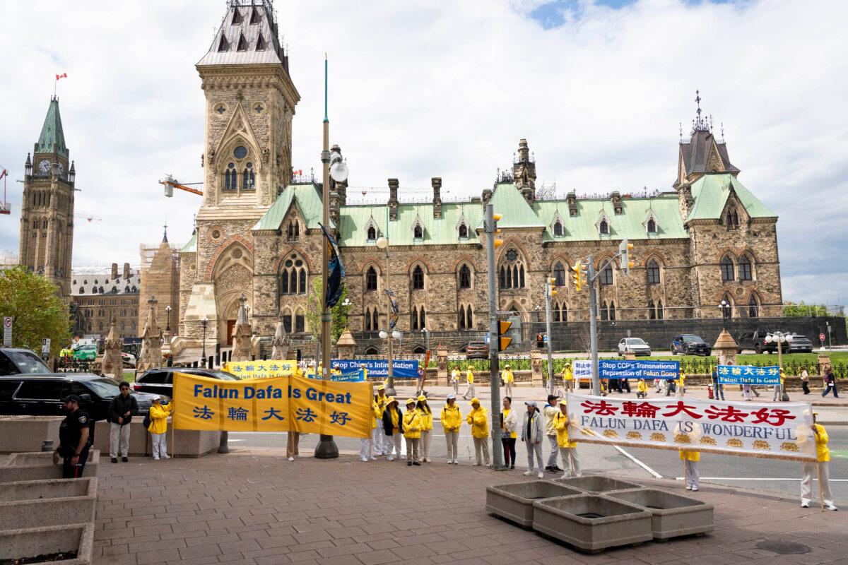 Falun Gong practitioners protest in Ottawa as Chinese Foreign Minister Wang Yi meets with Canadian Foreign Affairs Minister Anita Anand and Prime Minister Mark Carney on May 29, 2026. (Evan Ning/The Epoch Times)