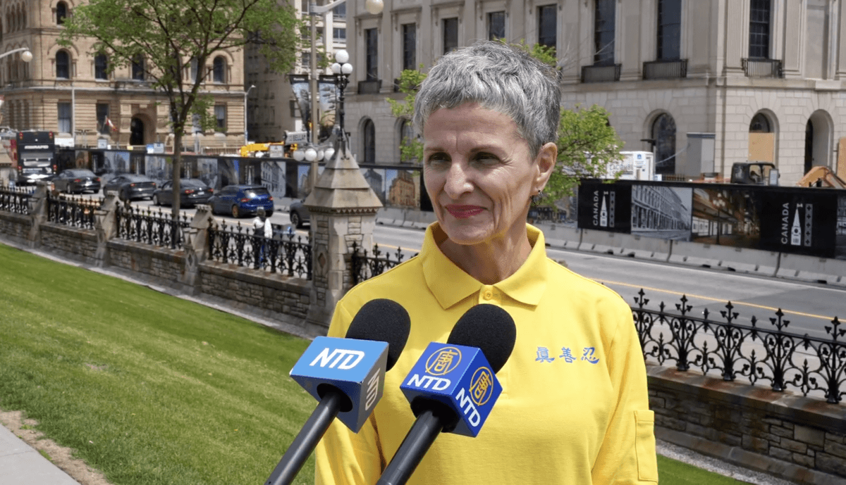Ruth Collins, a Falun Gong practitioner in Montreal, attends a rally on Parliament Hill on May 29, 2026. (NTD)