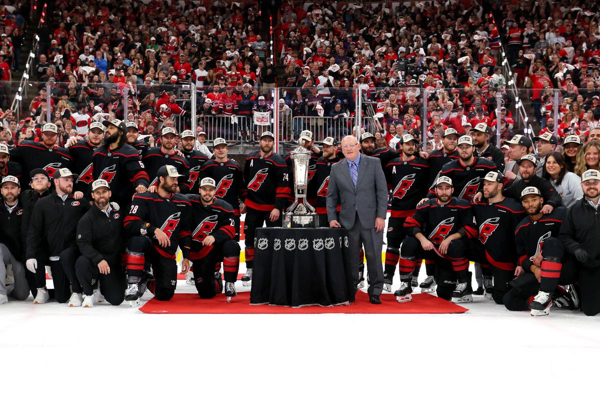 The Carolina Hurricanes pose with the Prince of Whales Trophy following a 6-1 victory over the Montréal Canadiens in Game Five of the Eastern Conference Final of the 2026 Stanley Cup Playoffs at Lenovo Center in Raleigh, North Carolina on May 29, 2026. (Bruce Bennett/Getty Images)