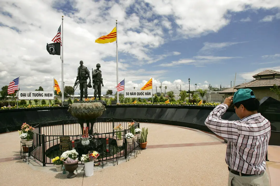 A man pays his respects at a Vietnam War Memorial in the Little Saigon neighborhood of Westminster, Calif., on April 28, 2005. Little Saigon, the largest Vietnamese enclave in the United States, was populated by large numbers of Vietnamese refugees, many of whom were “boat people,” in the late 1970's and 1980's. (David McNew/Getty Images)