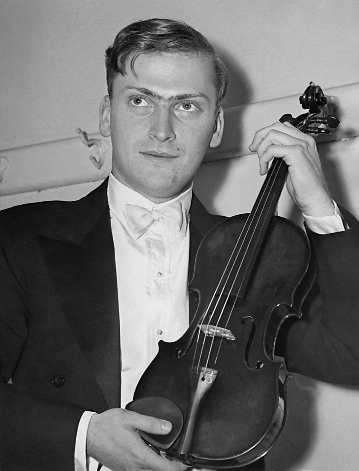 Violinist Yehudi Menuhin holds a Stradivarius violin backstage before a concert at the opening of the Southern California Symphony Association's 20th season on May 11, 1938. (AFP/Getty Images)
